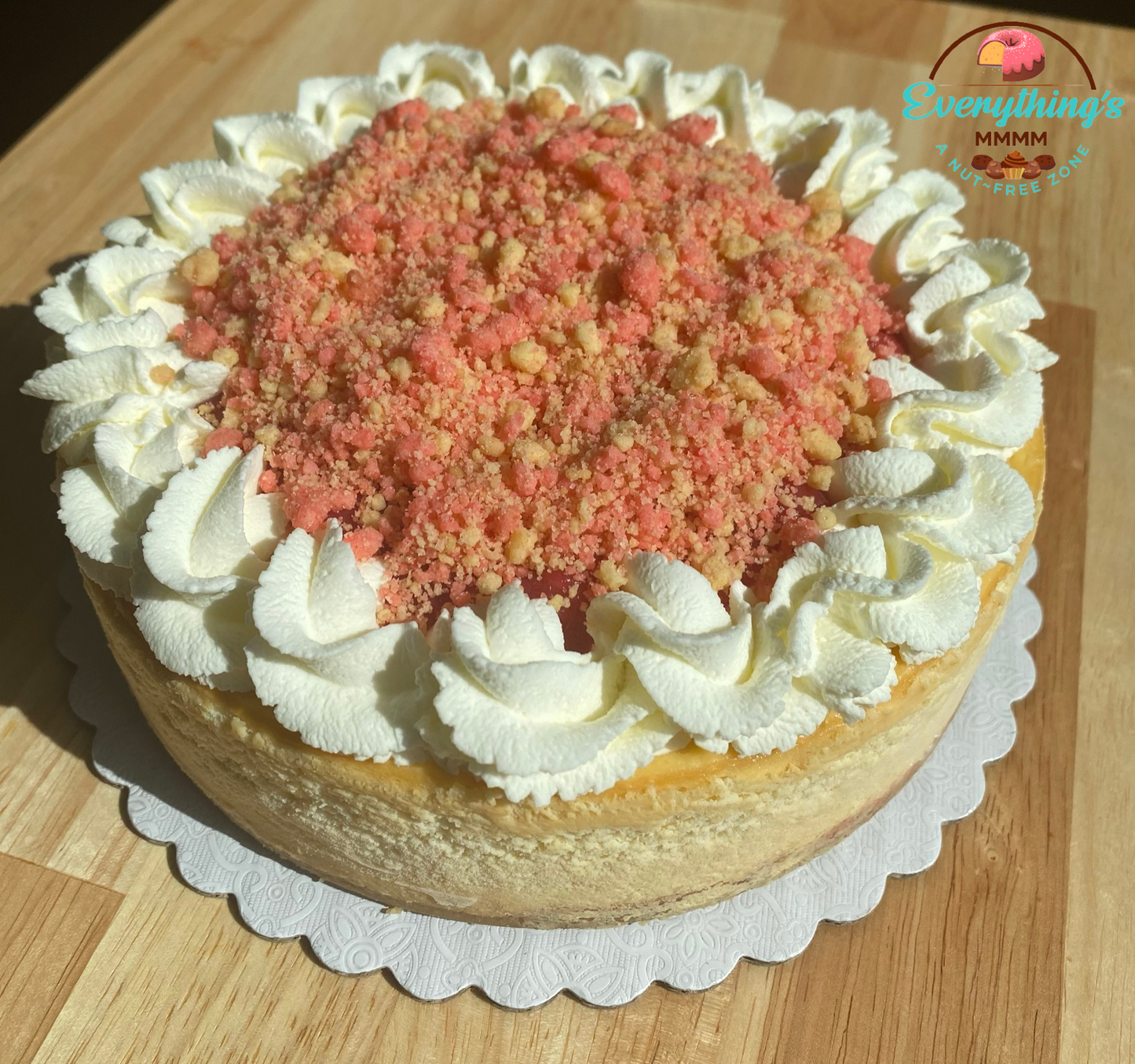 Strawberry Crunch Cheesecake. Strawberry shortcake crumbs. Whipped cream topping. Cookie Crust.
